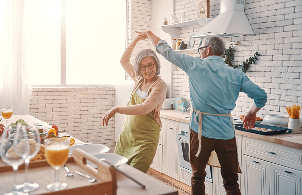 Older couple dancing in the kitchen